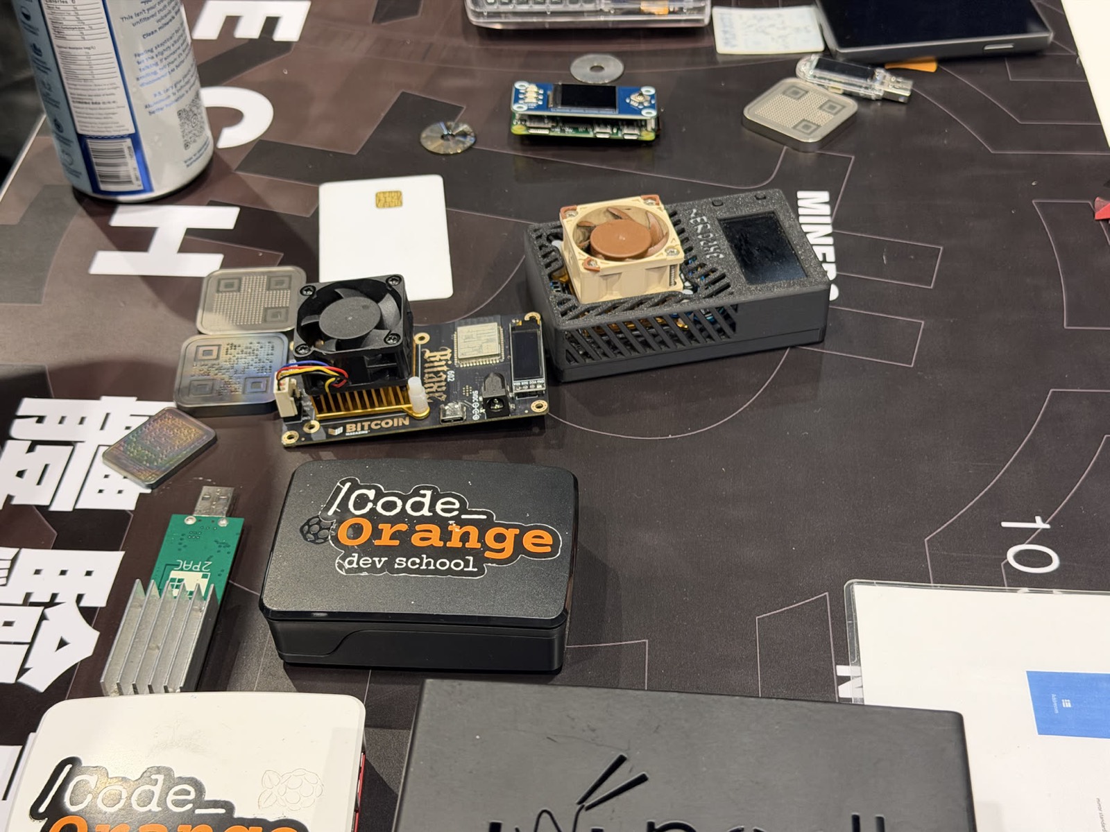 Bitcoin nodes, miners, and devices on a Code Orange workshop table